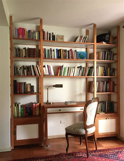 A Chair Sitting In Front Of A Book Shelf Filled With Books
