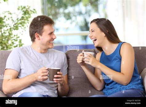 Dos Personas Hablando Y Riéndose Fuerte Sentado En Un Sofá En Casa