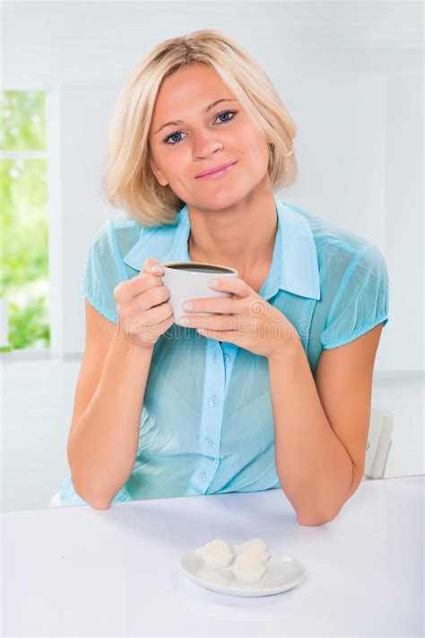 Beautiful Caucasian Female Sitting At Table And Drinking Coffee Stock