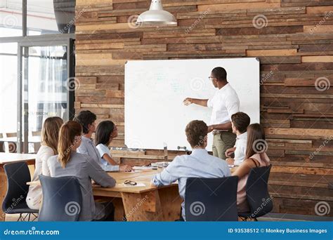 Young Black Man At Whiteboard Giving A Business Presentation Stock