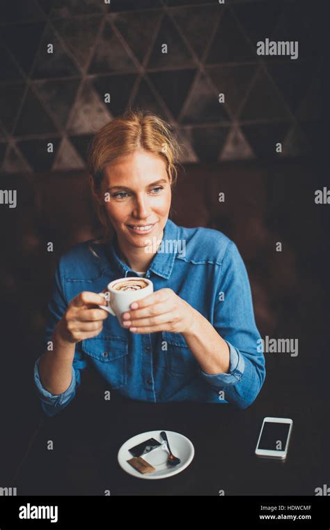 A Young Woman Drinking A Cup Of Coffee Hi Res Stock Photography And