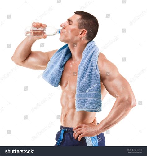 Young Muscular Man With Blue Towel Over Neck Drinking Water Isolated