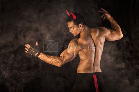 Shirtless Muscular Male Bodybuilder Dressed With Devil Costume By