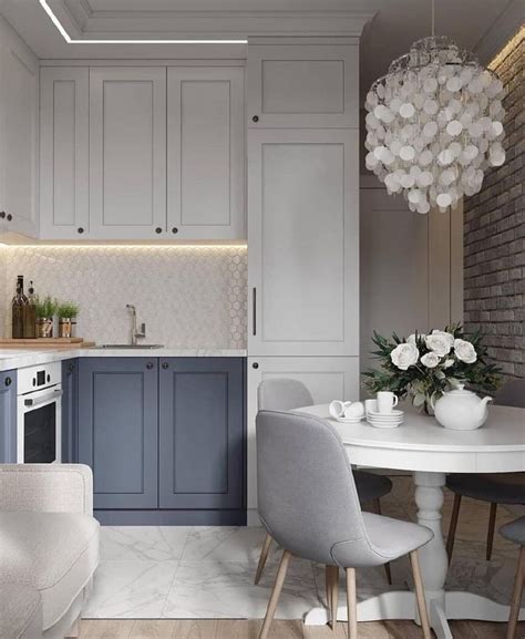 A Kitchen And Dining Area With White Cabinets Grey Walls And Wood