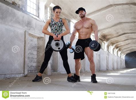 Awesome Fitness Couple Posing In Big Industrial Hall Stock Photo