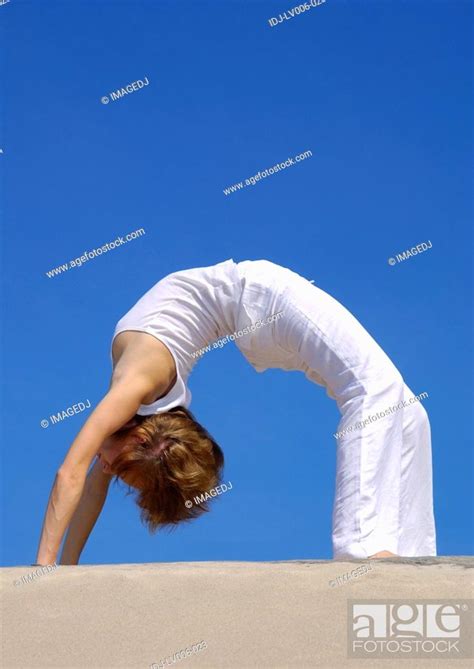 Side Profile Of A Young Woman Bending Over Backward Stock Photo