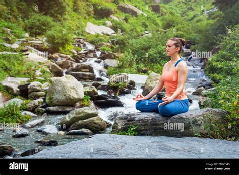 Woman Doing Yoga Meditation Asana Padmasana Lotus Pose Outdoors At