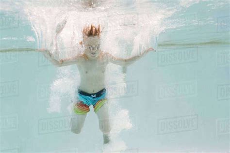 Boy 6 7 Jumping Into Swimming Pool Stock Photo Dissolve