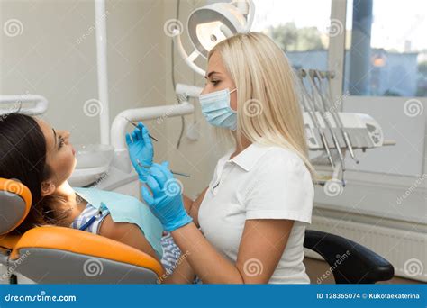 Pretty Girl Having Mouth Checkup In Hospital By Professional Female