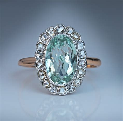 This ring has a vintage shape, but it can easily blend in with modern pieces, as it's not too big. Aquamarine Rose Cut Diamond Vintage Engagement Ring - Antique Jewelry | Vintage Rings | Faberge Eggs