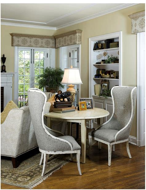 A Dining Room Table With Chairs Around It