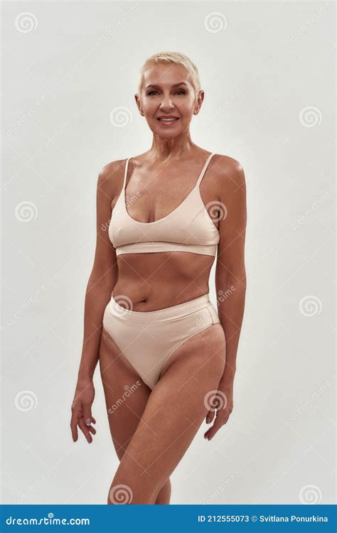 Attractive Caucasian Senior Woman In Underwear Looking At Camera While