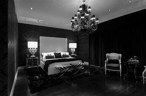 A Black And White Bedroom With Chandelier