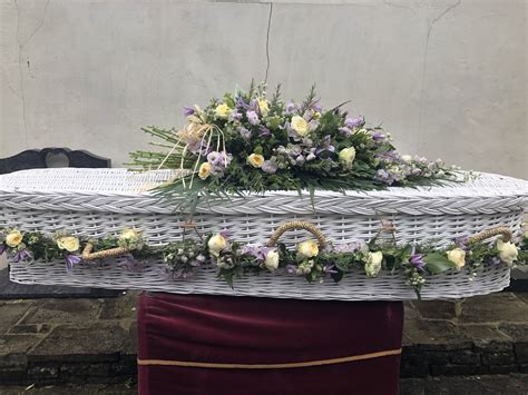 We use the freshest flowers in our arrangements. beautiful soft lilac and lemon wicker casket garland and ...