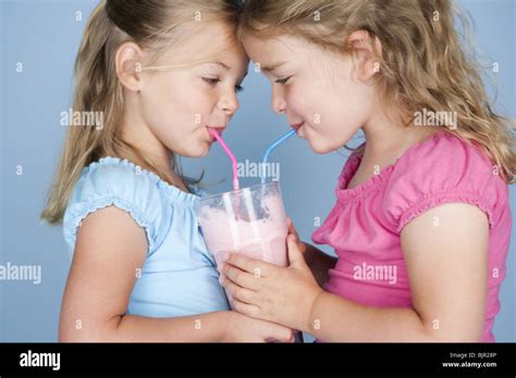 Two Girls Sharing A Milkshake Stock Photo Alamy