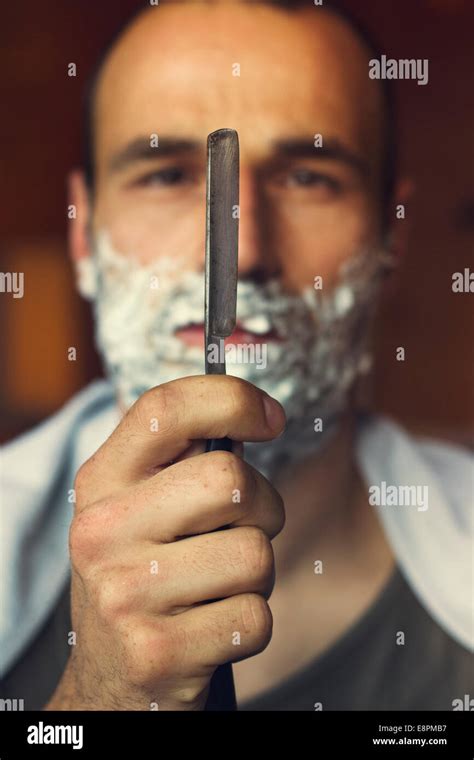 Young Man Getting An Old Fashioned Shave With Straight Razor Closeup