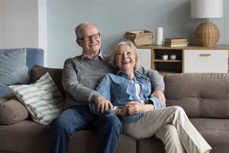 cheerful relaxed older married couple resting on home couch stock image image of comfortable