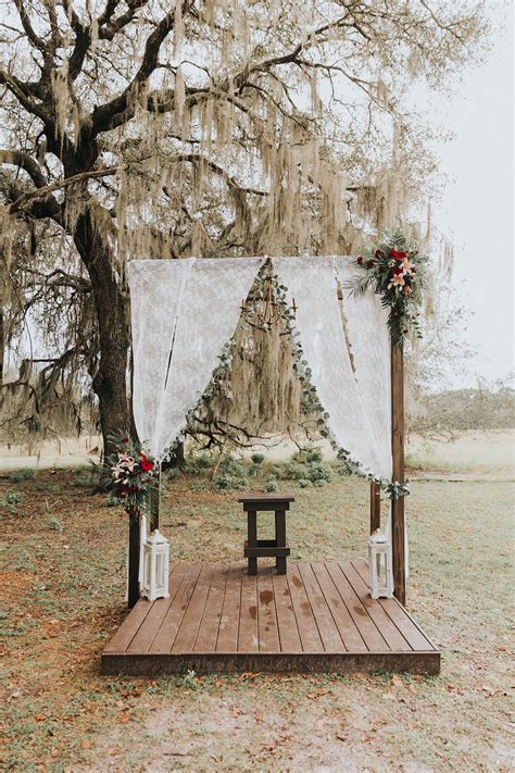 Rustic And Romantic Wooden Wedding Ceremony Arch On Platform With Lace