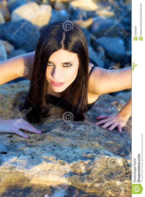 Aggressive Woman On Rocks With Makeup Royalty Free Stock