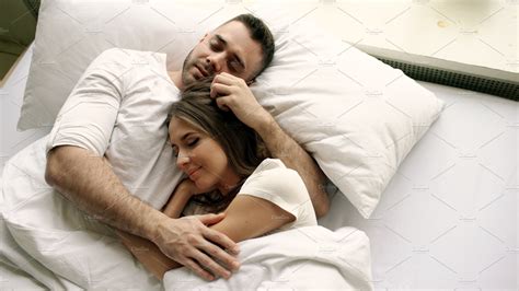 Young Beautiful And Loving Couple Kiss And Hug Into Bed While Waking Up In People Images