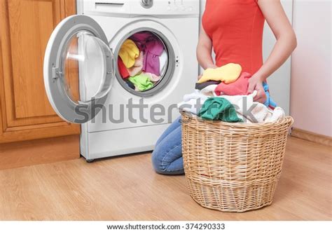 You also may worry about dark colors bleeding onto other fabrics. Woman Loading Washing Machine Colored Clothing Stock Photo ...