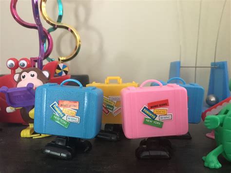 There Are Many Toy Suitcases On The Table