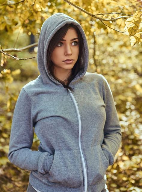 A Charming Girl Wearing A Gray Hoodie In The Autumn Park Stock Photo