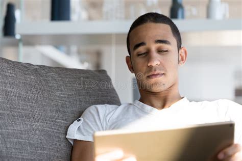 Man Lying On Sofa And Looking At Tablet Stock Image Image Of Couch