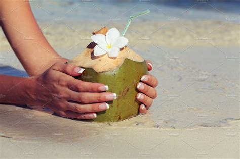 coconut in the hands of the girls ~ people photos ~ creative market