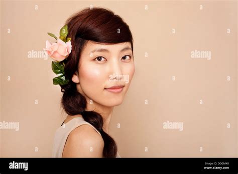 Mid Adult Woman Wearing Flower In Hair Portrait Stock Photo Alamy
