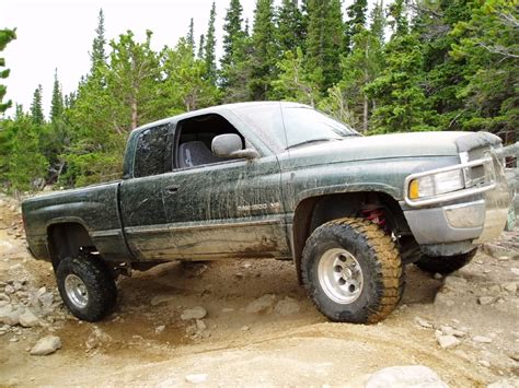 Has a roll up leather tonneau cover that locks down and has inner plastic bedliner with a bed extender. lifted pics ???? - DodgeForum.com