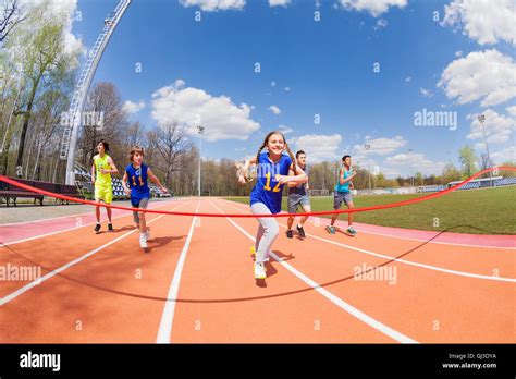 Young Sprinters Running To The Finish Line Stock Photo Alamy