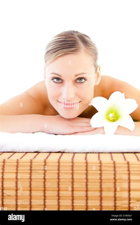 Close Up Of A Radiant Woman Lying On A Massage Table With A Flower