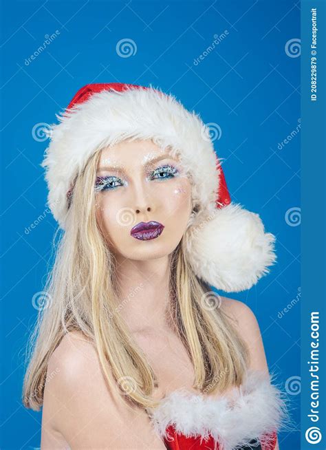 beautiful girl in santa hat party celebration and christmas blonde female model dressed in a