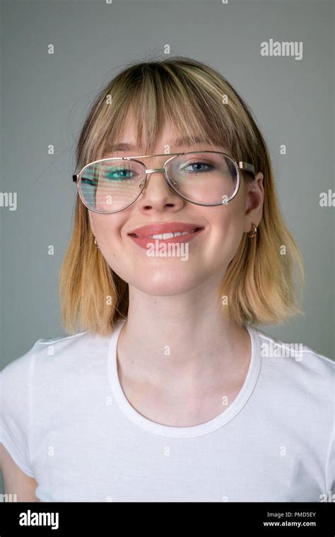 Portrait Of A Beautiful Girl In Glasses With Short Blond Hair Stock