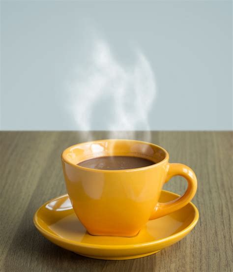 Free Photo Steaming Coffee Cup On Table