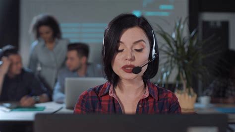 Female Operator In Call Center Looking At Camera And Talking To A Customer Stock Video Footage