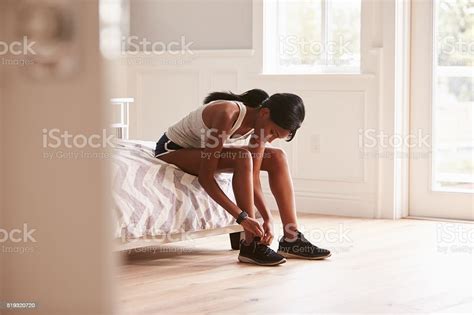 Young Black Woman Ready For Exercising Tying Her Sports Shoe Stock