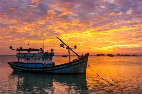 Fishing Boats Against The Background Of A Purple Sunset Stock Photo