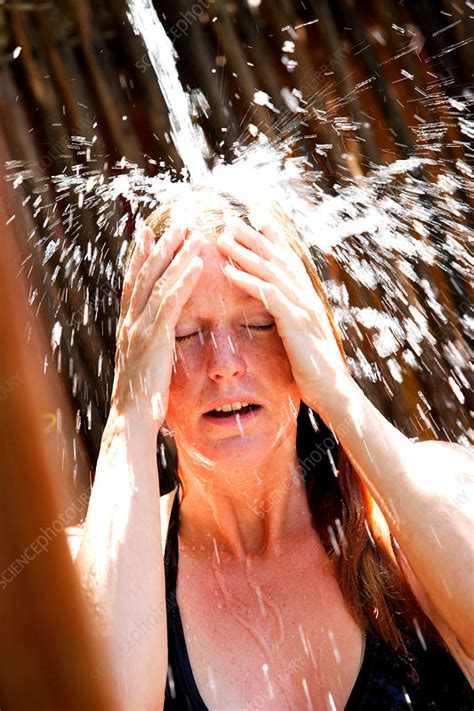 Woman Taking Outdoor Shower Stock Image C Science Photo Library