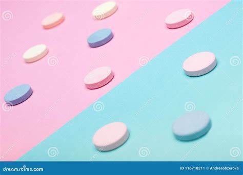 assortment of various colourful pills on pastel coloured background medication and prescription