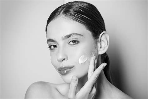 Premium Photo Beautiful Woman Spreading Cream On Her Face