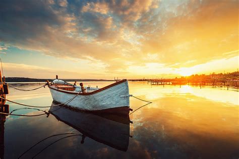 Beautiful Sunset Over Calm Lake And A Boat With Sky