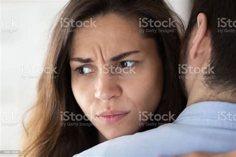 Frustrated Woman Hugging Man Having No Power To Forgive Cheating Stock