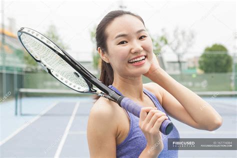 Portrait Of Young Female Tennis Player On Tennis Court — Lifestyle