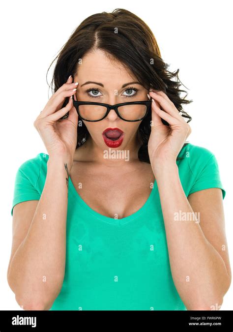 Shocked Young Woman Looking Over Her Glasses With Her Mouth Open In