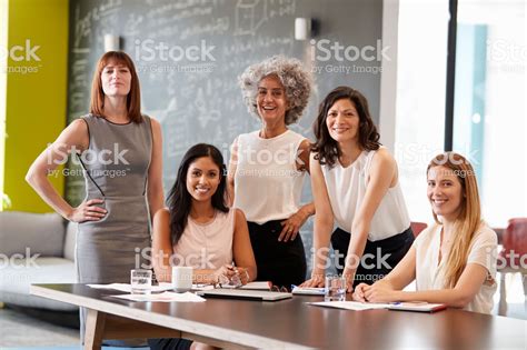 Five Female Colleagues At A Work Meeting Smiling To Camera Business