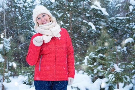 Woman Plays With Snow And Walks Across Snowfall In Forest Stock Image
