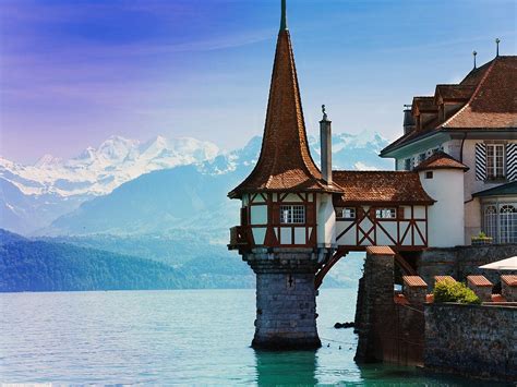The Oberhofen Castle With Its Tower On The Water Lies On The Right