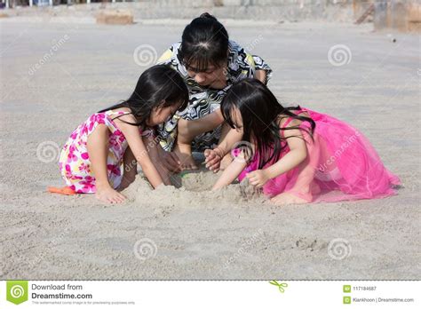 Asian Chinese Mum And Daughters Playing Sand Together Stock Image